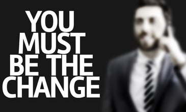 Business man with the text You Must Be The Change in a concept i