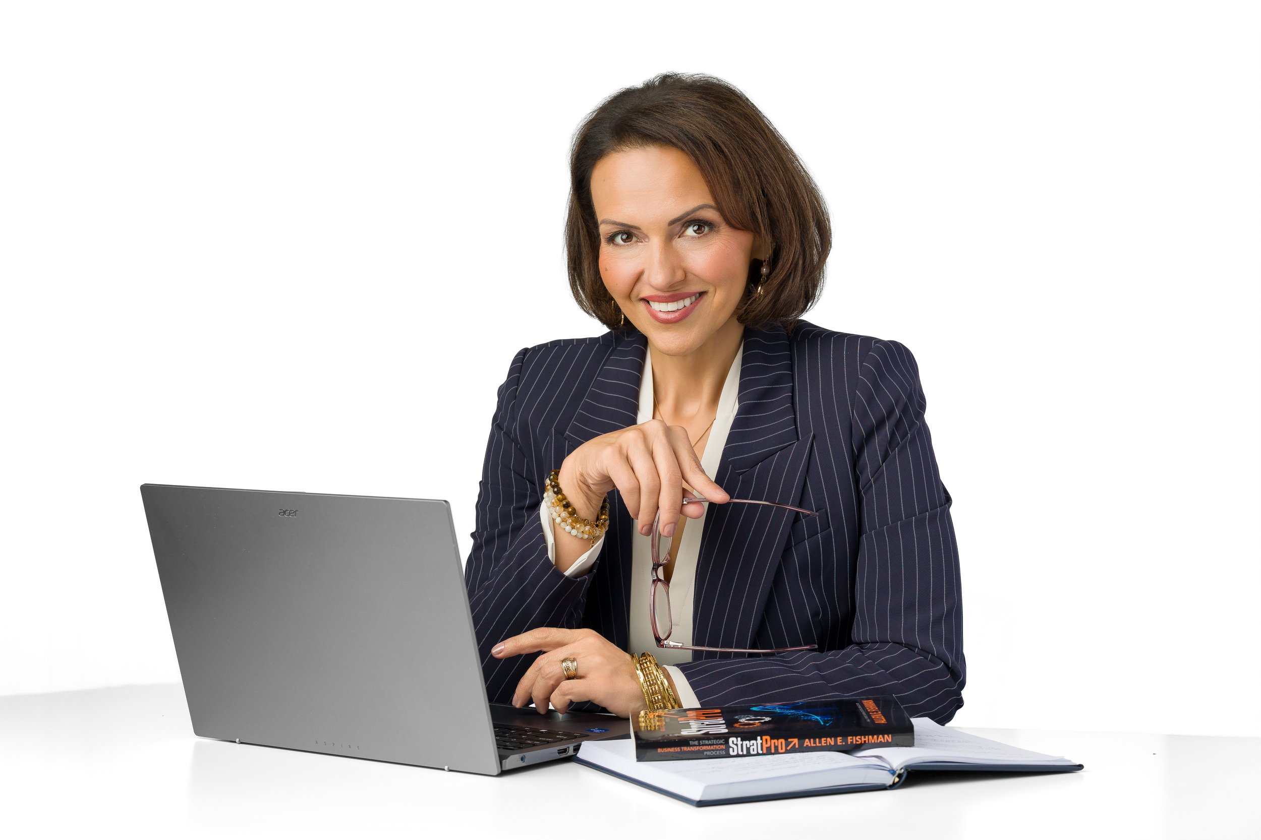 Eva Safar poses in front a laptop and a stack of books