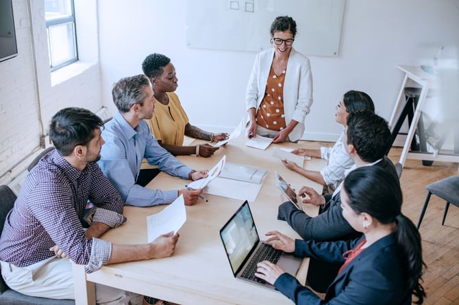 a group of professionals meet in a board room