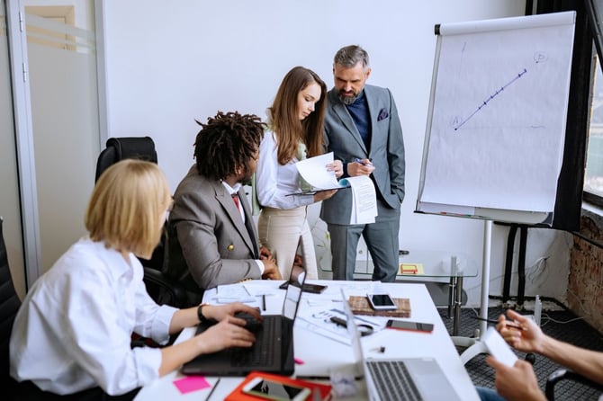 a management team deliberates on their current performance system